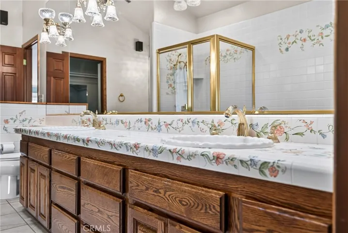 Primary Ensuite Bathroom with dual sinks, vanity area, soaking tub, shower, walk in closet- artisan tilework