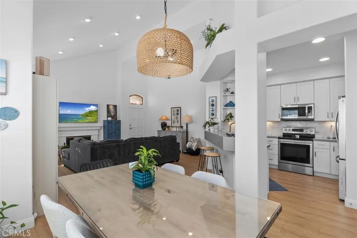 Luxurious Open Living Room & dining area W/ Fireplace. Plantation Shutters