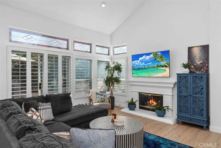 Luxurious Open Living Room. W/ Fireplace. Plantation Shutters