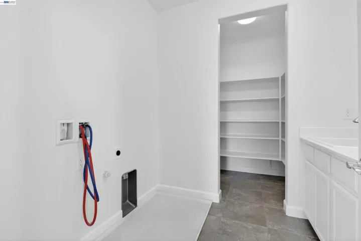 LAUNDRY ROOM WITH CLOSET AND SINK