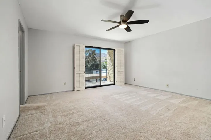Primary bedroom with balcony