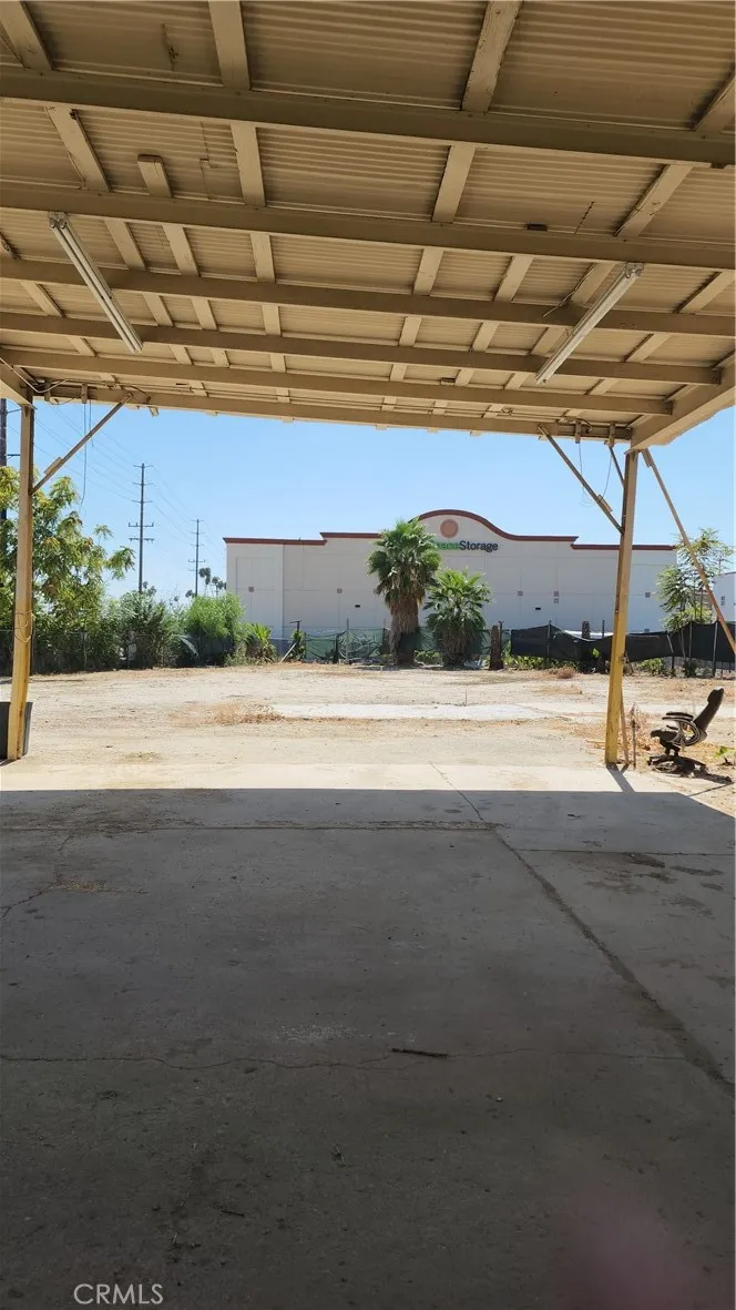 unit #2 address 3130 view from the back of fence of the property to the private entry backyard, large vehicle carport and private access.