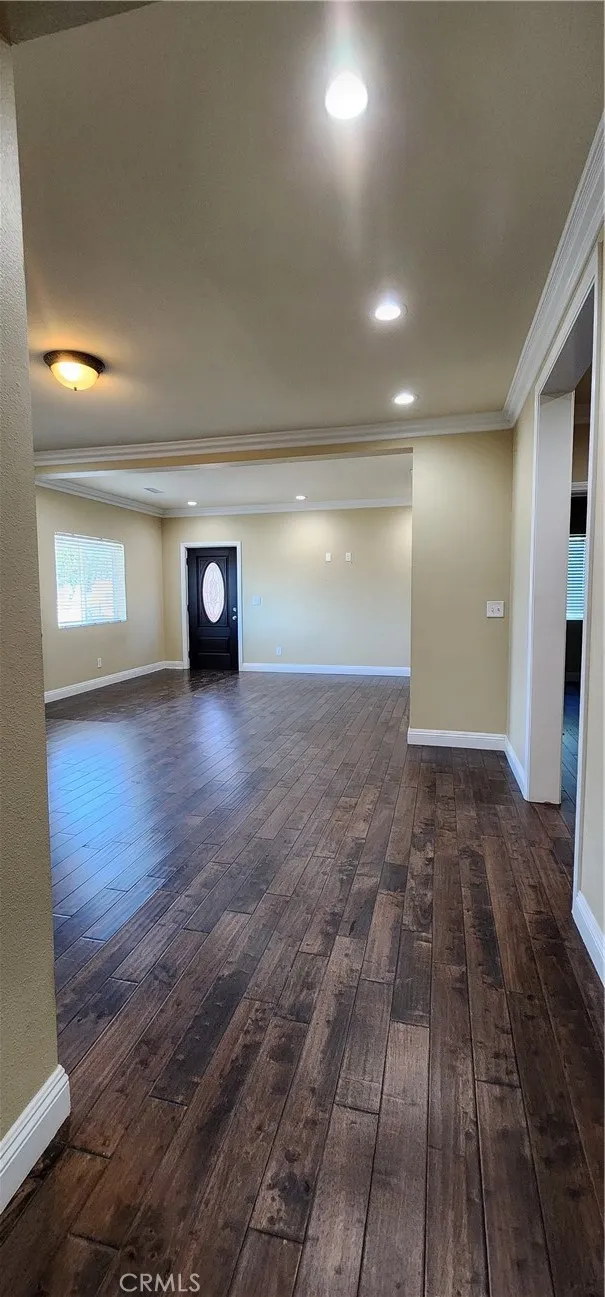 unit #2 address 3130 living room and dining room view, all wood laminate, crown molding