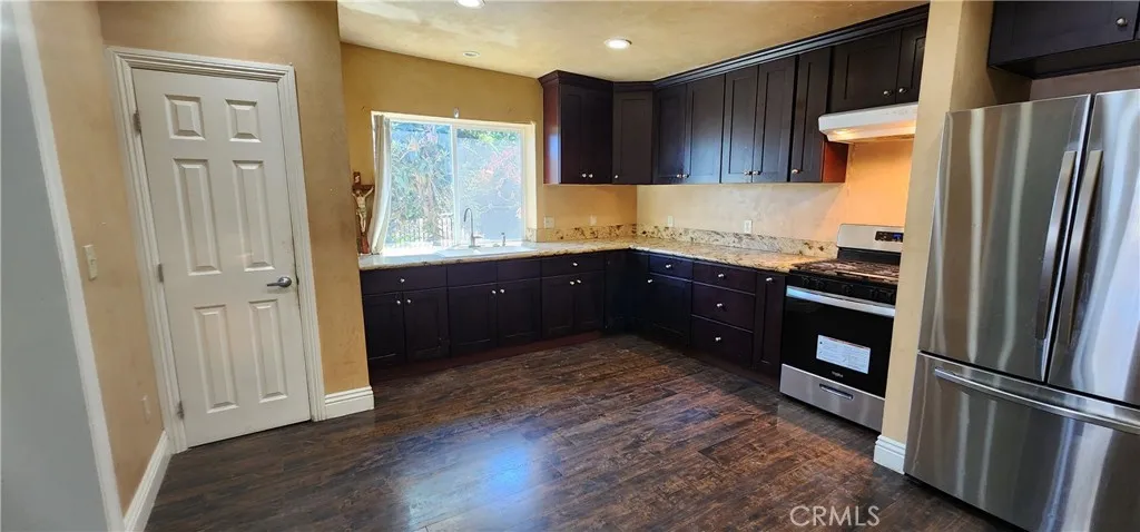 unit #1 address 3112 View of large kitchen, pantry with granite counter tops and crown molding throughout the inside of the unit.