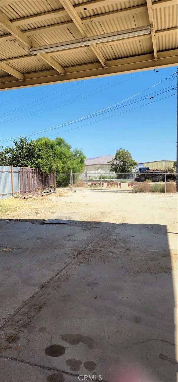 View to the back of the private storage lot with large vehicle carport