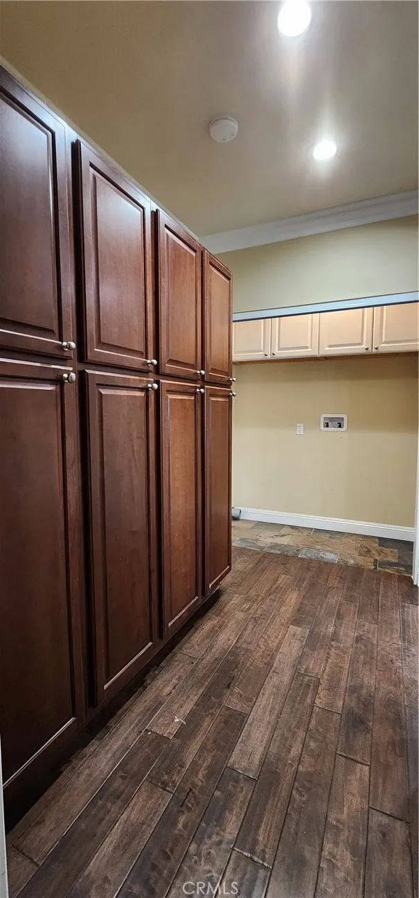 unit #2 address 3130 laundry area, with washer dryer hookups and large wood custom cabinets