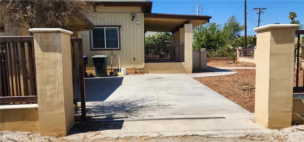 unit #1 address 3112 view of side of the home with private remote entry and yard. Stucco