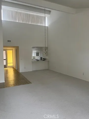 Another view of spacious living/dining room with plenty of natural light