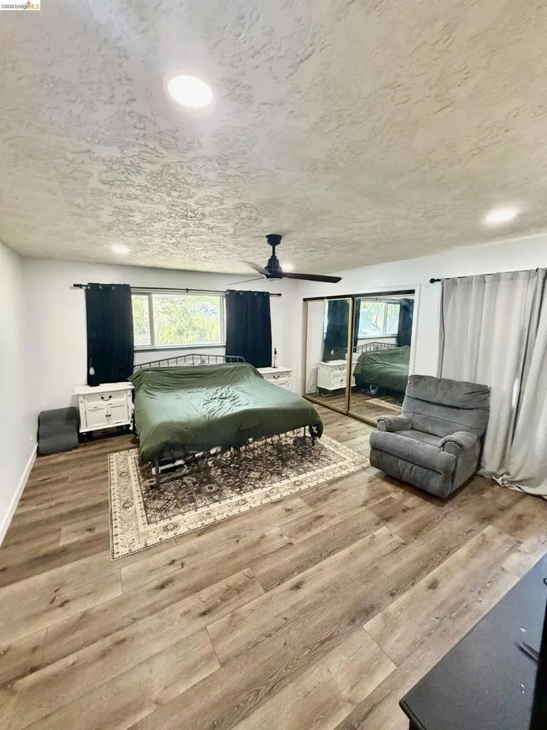 Wood-finish flooring, recessed lighting, and a ceiling fan