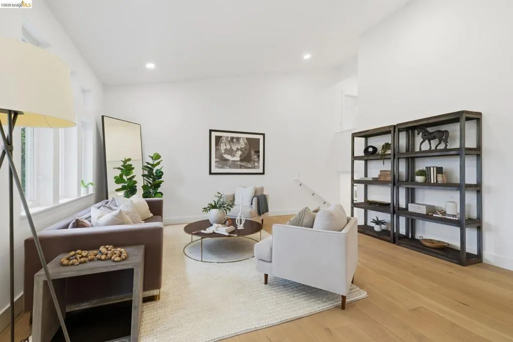 Hardwood-finish flooring, recessed lighting, expansive windows, built-in shelving, and a bright, neutral color palette Hardwood-finish flooring, recessed lighting, expansive windows, built-in shelving, and a bright, neutral color palette