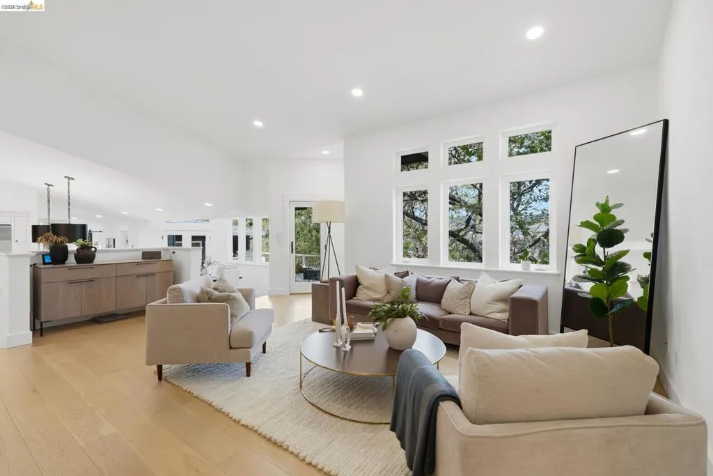 Vaulted ceilings, recessed lighting, expansive windows, wood-finish flooring, and a built-in console cabinet Vaulted ceilings, recessed lighting, expansive windows, wood-finish flooring, and a built-in console cabinet