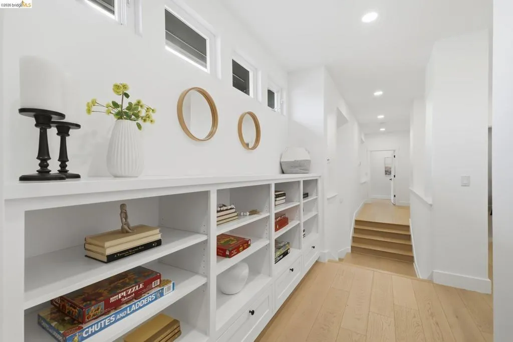 Built-in shelving and cabinetry, wood-finish flooring, recessed lighting, and transom windows Built-in shelving and cabinetry, wood-finish flooring, recessed lighting, and transom windows