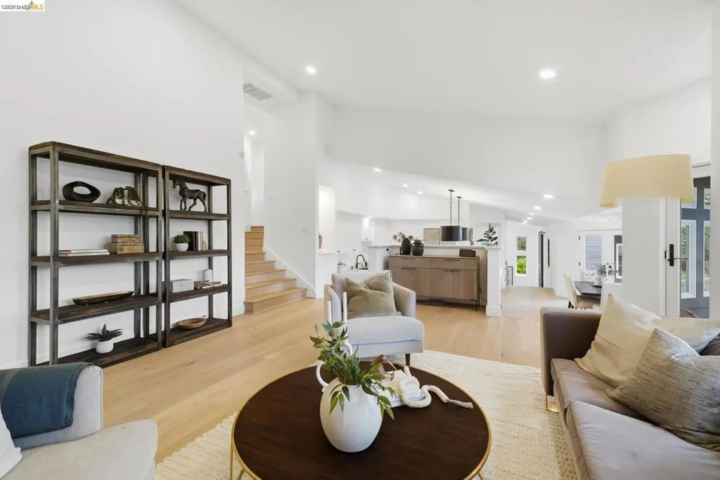 Vaulted ceilings, recessed lighting, and light wood-finish flooring characterize this open living space Vaulted ceilings, recessed lighting, and light wood-finish flooring characterize this open living space