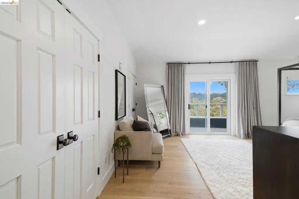 Wood-finish flooring, recessed lighting, and sliding glass doors Wood-finish flooring, recessed lighting, and sliding glass doors