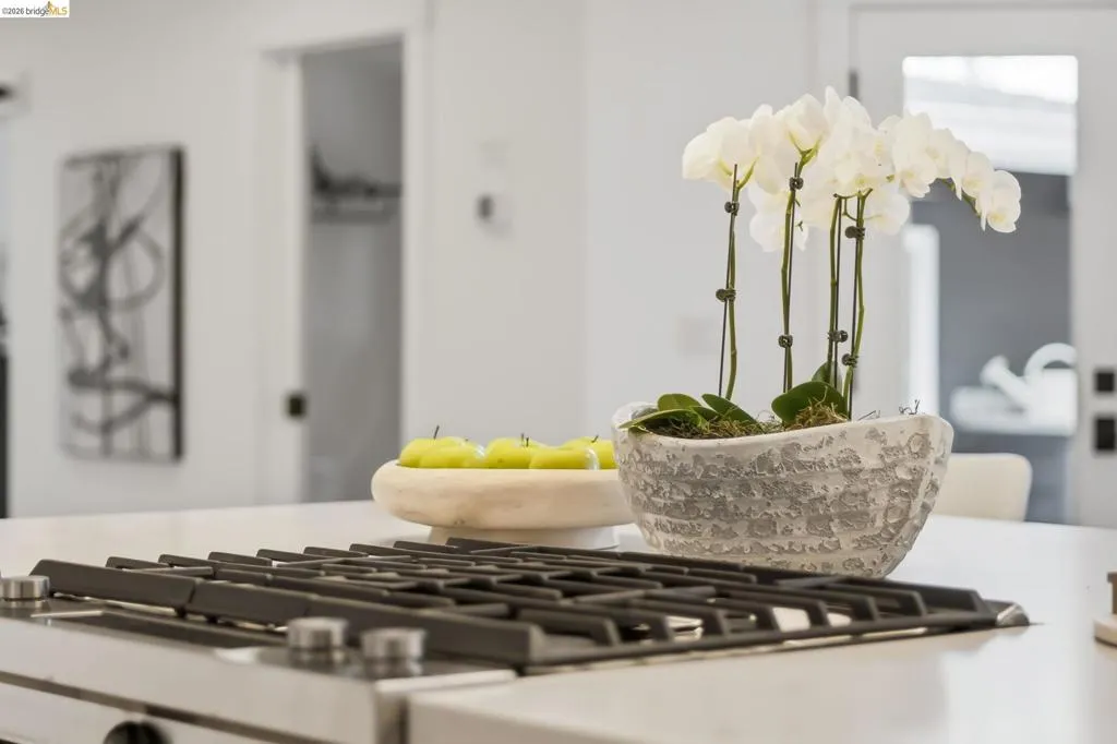 Built-in cooktop with stainless steel grates set into a light-toned countertop Built-in cooktop with stainless steel grates set into a light-toned countertop
