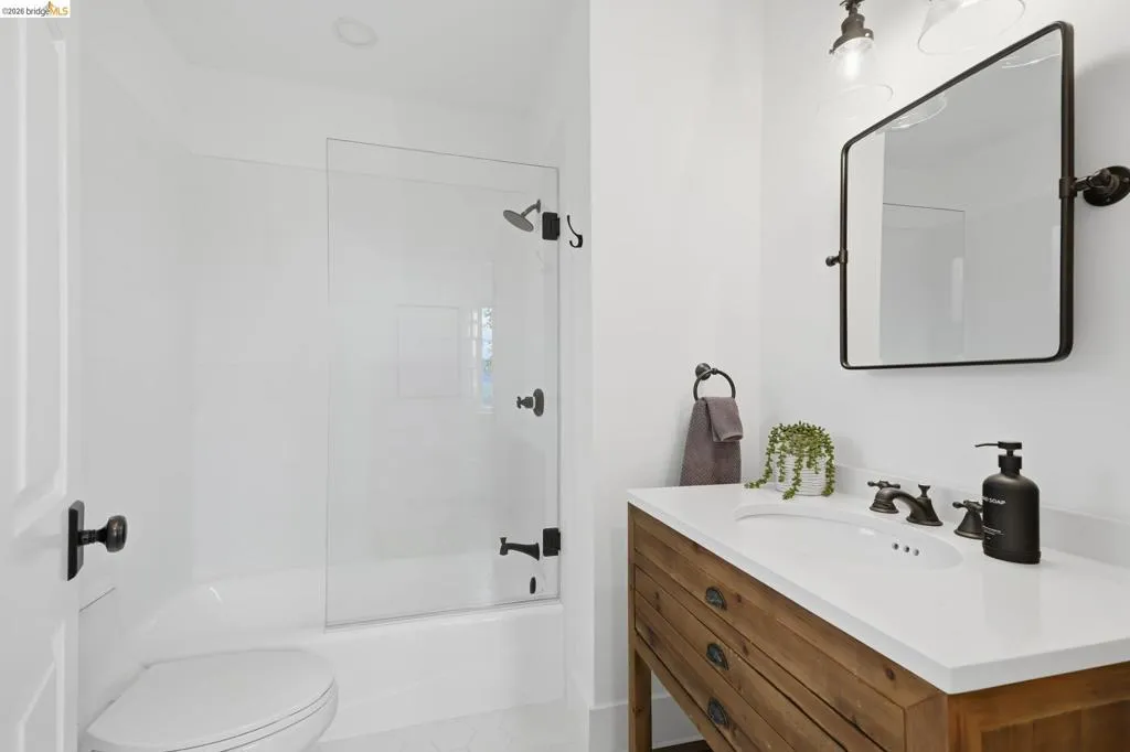 Wood-finish vanity with an integrated sink and white countertop Wood-finish vanity with an integrated sink and white countertop