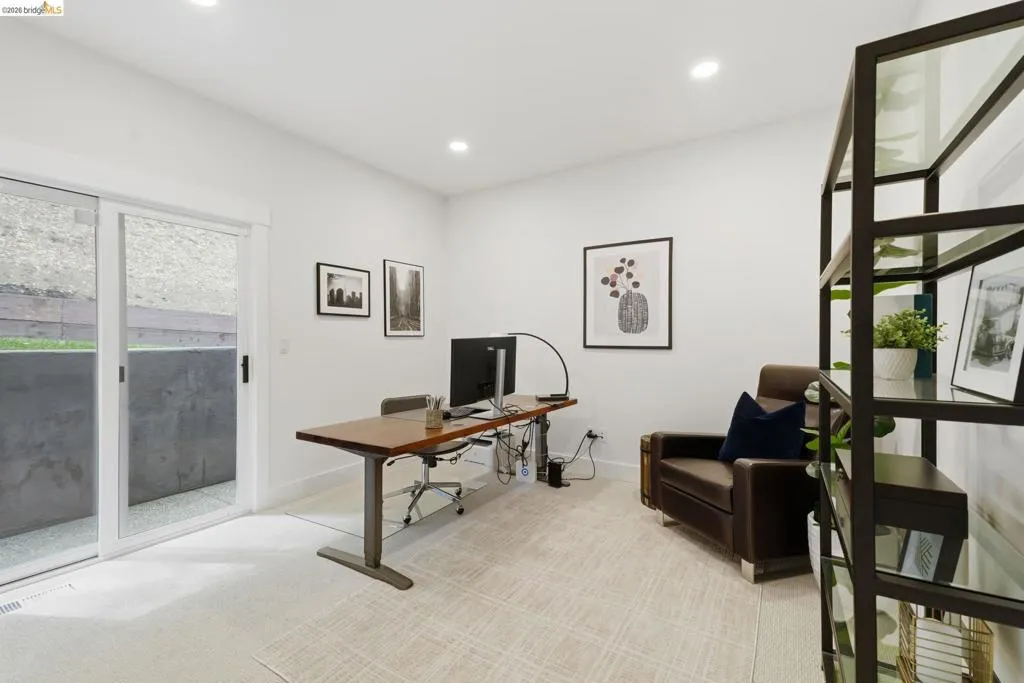 Recessed lighting, light-toned carpeting, white walls, and a sliding glass door Recessed lighting, light-toned carpeting, white walls, and a sliding glass door