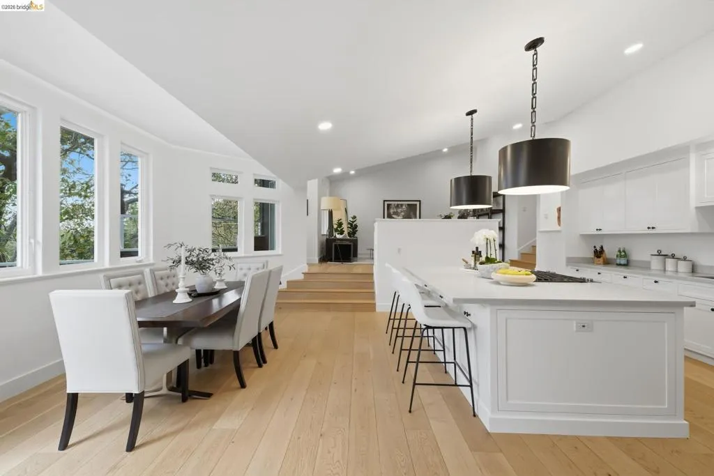 Kitchen island with a light-toned countertop, white cabinetry, and pendant lighting Kitchen island with a light-toned countertop, white cabinetry, and pendant lighting