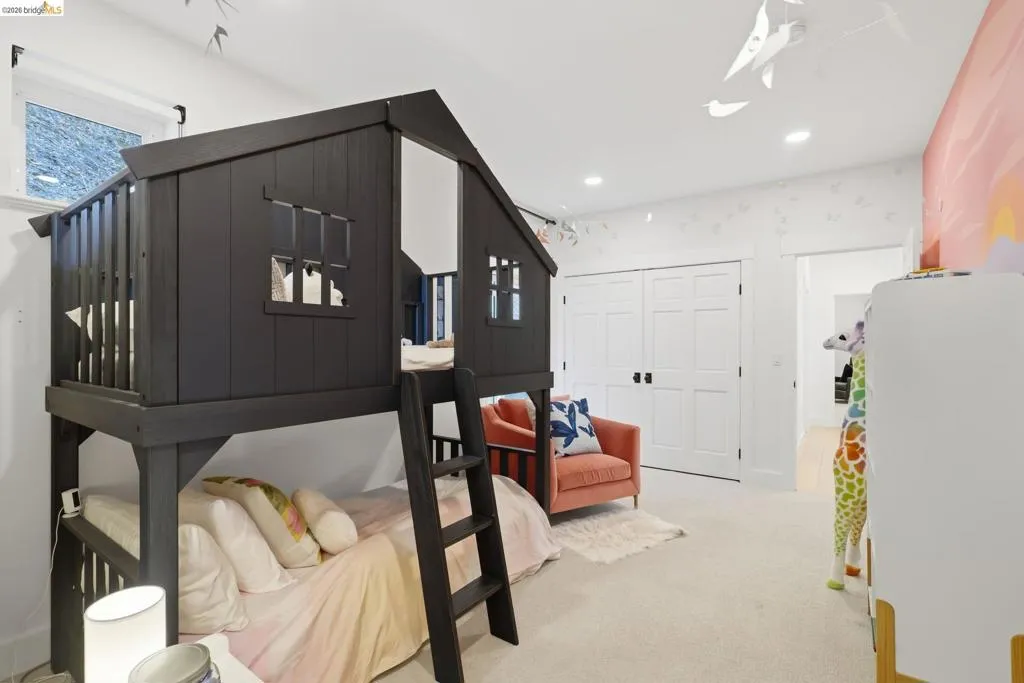 Built-in playhouse bunk bed with ladder, recessed ceiling lighting, and panel doors Built-in playhouse bunk bed with ladder, recessed ceiling lighting, and panel doors