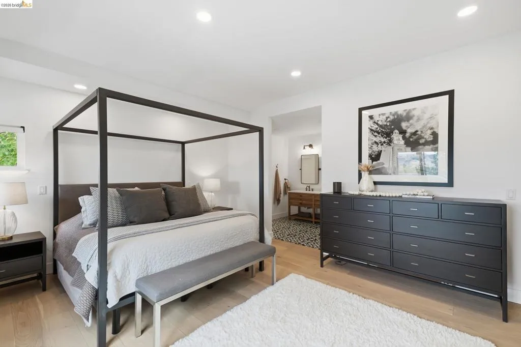 Recessed ceiling lighting, wood-finish flooring, and a window with exterior greenery Recessed ceiling lighting, wood-finish flooring, and a window with exterior greenery