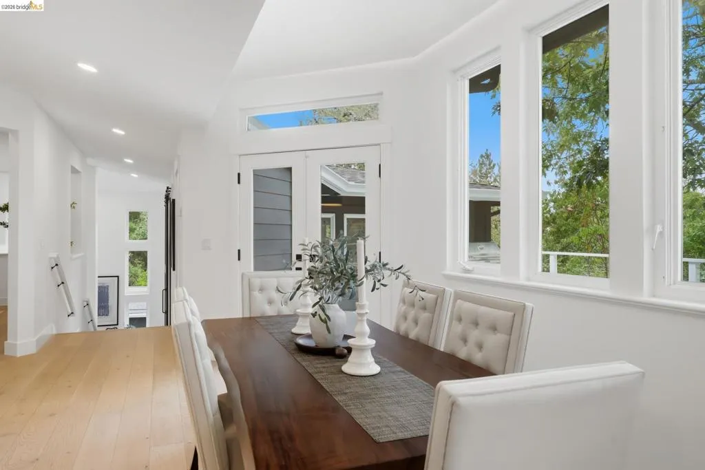 Recessed lighting, wood-finish flooring, white walls, multiple windows, and a glass-paneled door Recessed lighting, wood-finish flooring, white walls, multiple windows, and a glass-paneled door