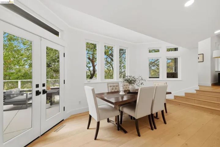 Light wood-finish flooring with white walls and abundant natural light from multiple windows