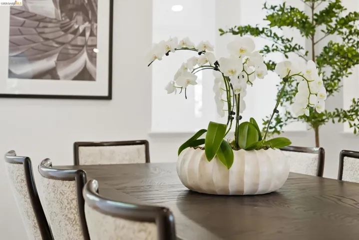Dark-stained wood-finish table with upholstered dining chairs