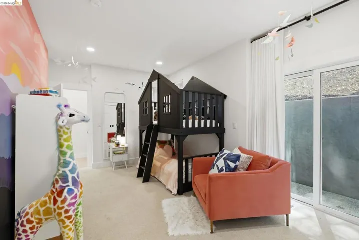 White walls with recessed lighting, large glass sliding door, and wall-to-wall carpeting