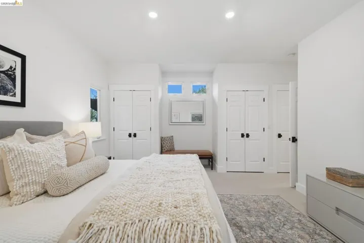 Recessed lighting illuminating the carpeted interior, with white walls and trim throughout