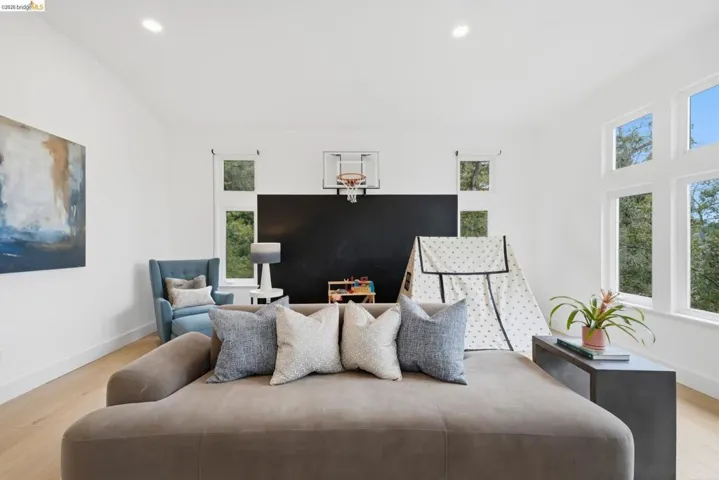 Recessed lighting, wood-finish flooring, multiple windows, and a blackboard wall