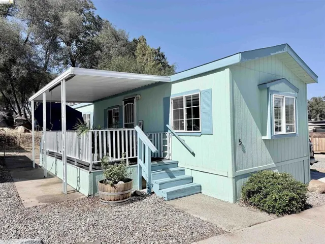 View of front of home with a wooden deck