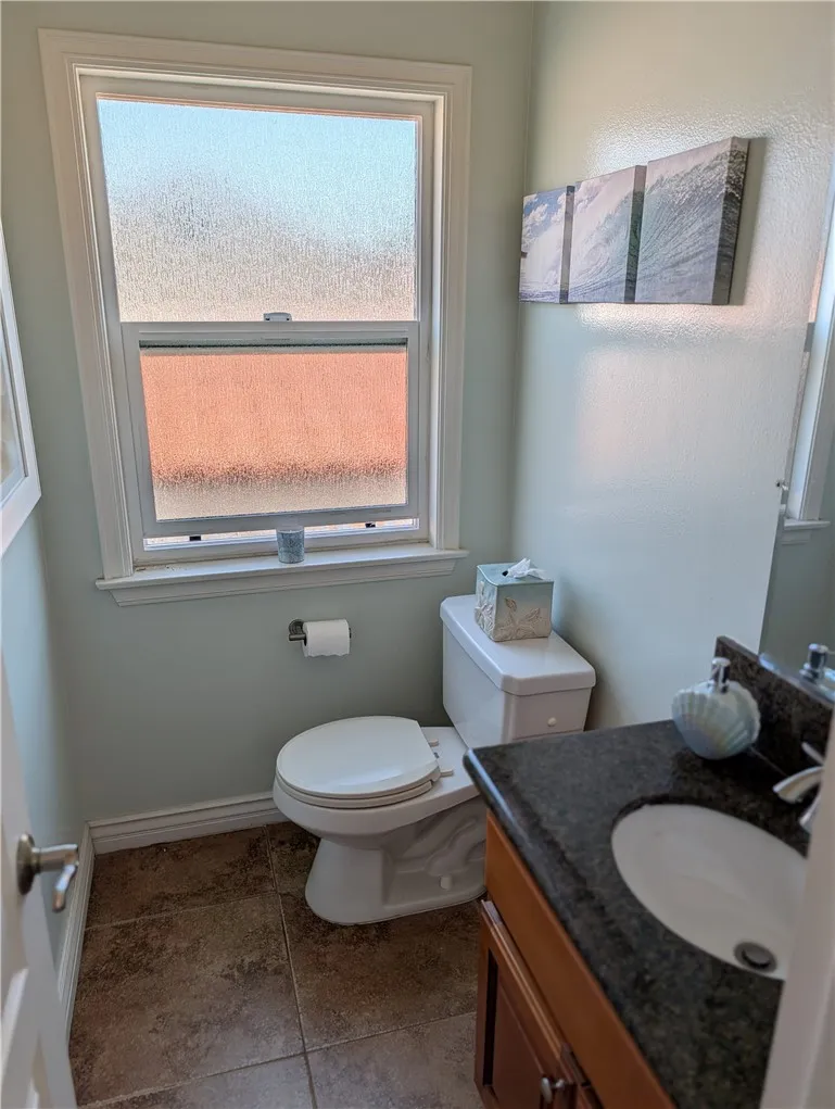 Conveniently located powder room featuring natural light and stylish finishes.