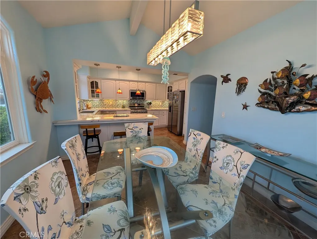 Elegant dining area with statement lighting and an open connection to the kitchen, ideal for hosting family and friends.