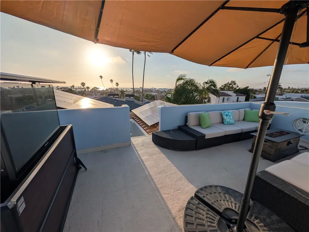 Inviting rooftop lounge area with shaded-seating and sweeping coastal views.