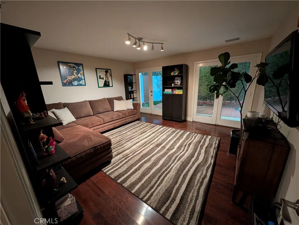 Second Den view showcasing the comfortable seating area and generous open layout.