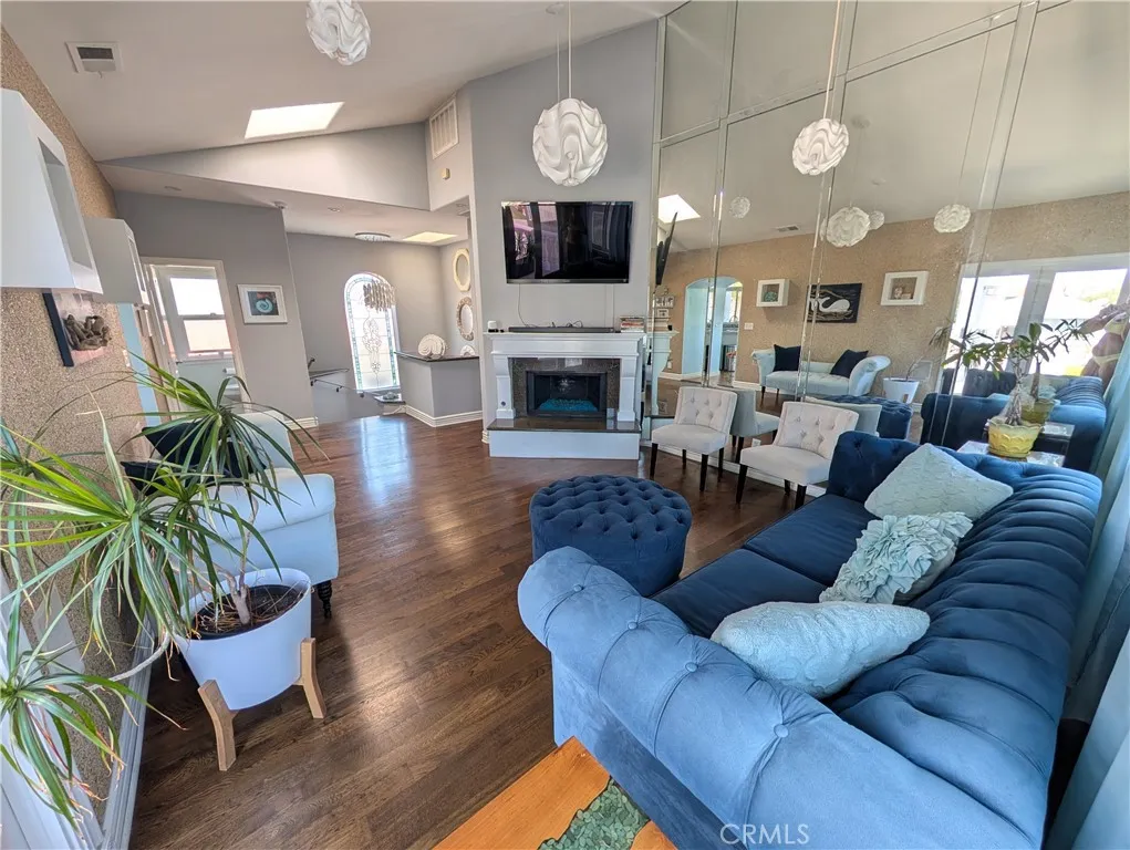 Inviting living room with a fireplace, hardwood floors and seamless flow into the surrounding living spaces.