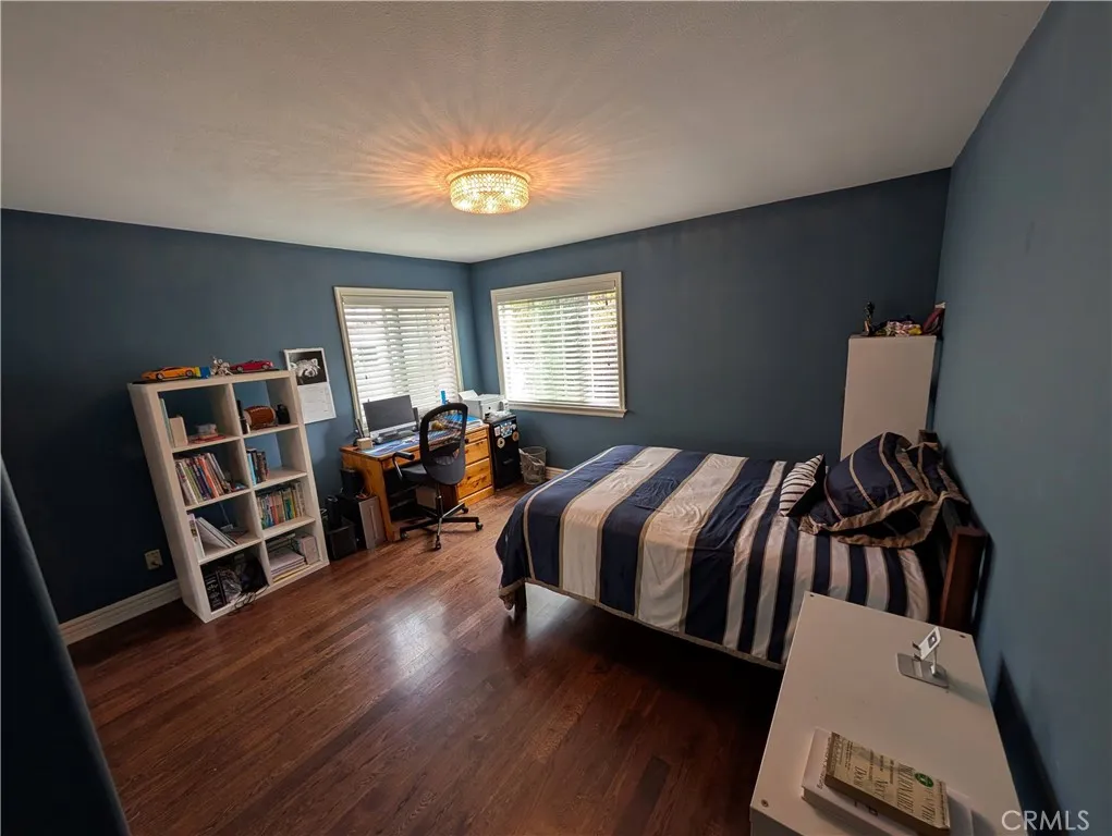 Spacious second bedroom featuring hardwood floors, generous proportions and abundant lighting.