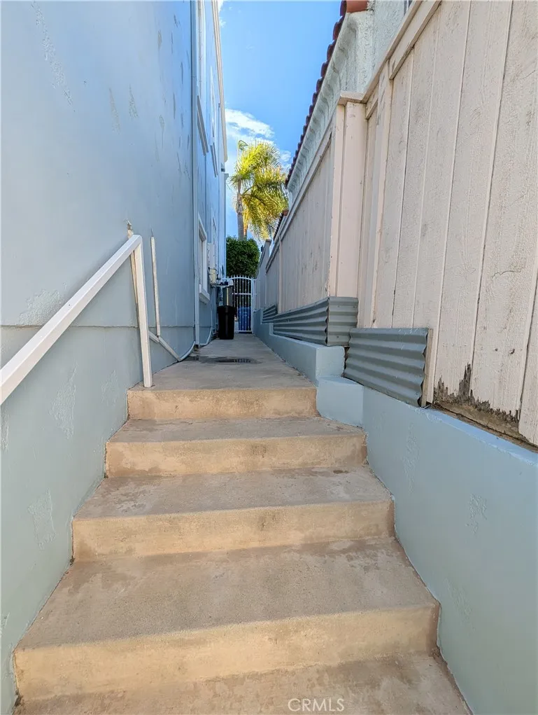 Additional side access with steps leading to the homes private outdoor area.