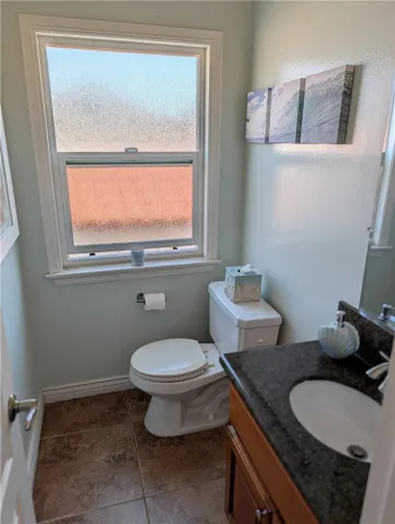 Conveniently located powder room featuring natural light and stylish finishes.