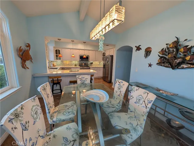 Elegant dining area with statement lighting and an open connection to the kitchen, ideal for hosting family and friends.