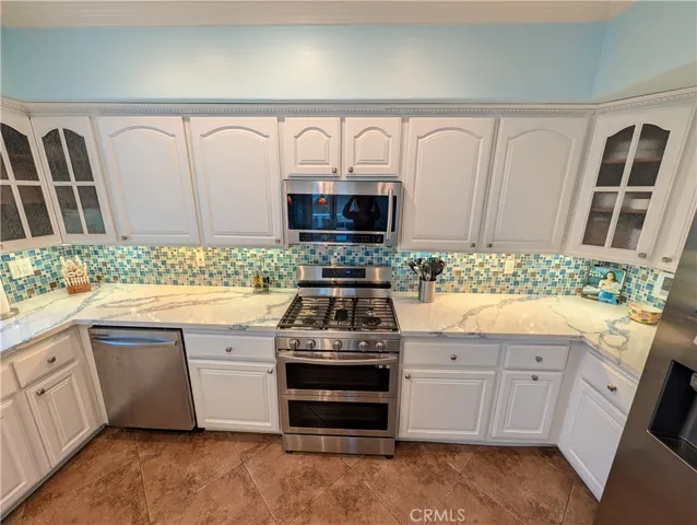 Kitchen showcasing abundant cabinetry, stainless steel appliances.