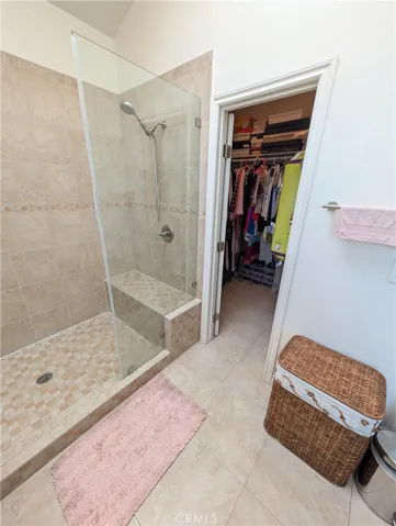 Glass-enclosed shower finished with neutral tile for a clean, timeless look.