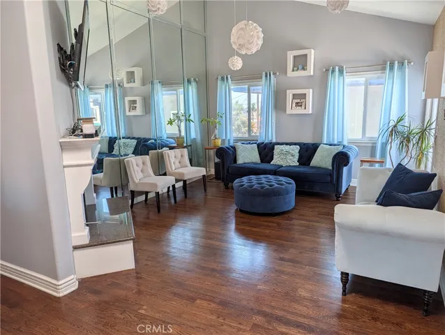 Spacious light-filled living area featuring hardwood floors & inviting layout.