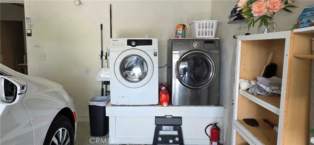 Laundry area in Garage with Large Capacity Washer and Dryer