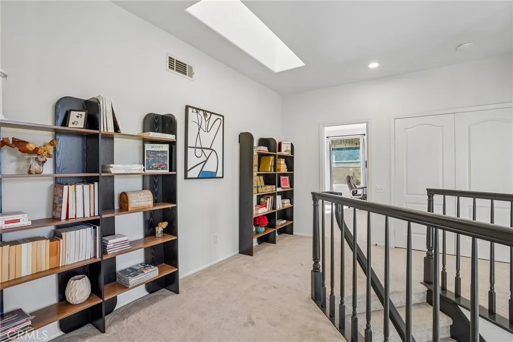 Elegant upstairs hallway leading to the luxurious primary suite and two additional bedrooms.