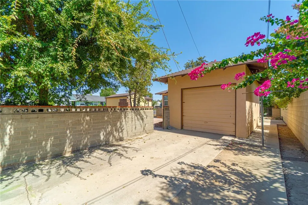 Gated side entry to the attached garage with room for a boat or extra cars