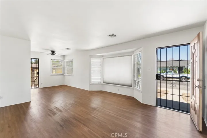 Living room with ceiling fan and natural light