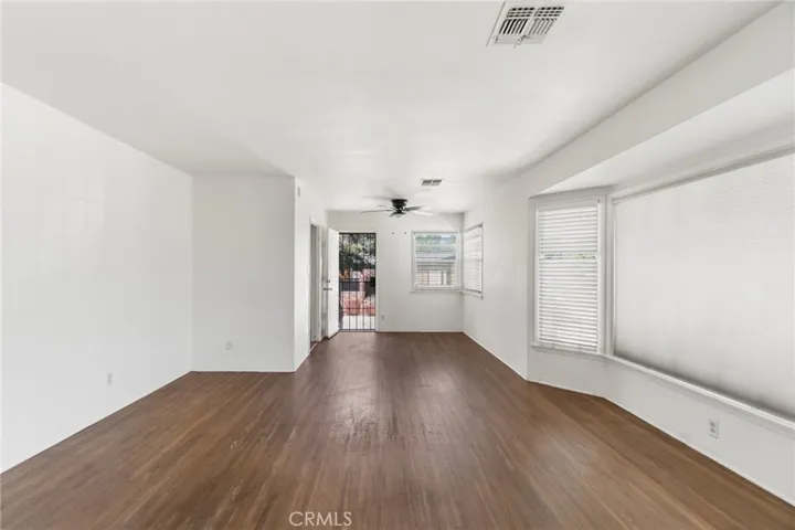 Living room with wood floors and a wide picture window
