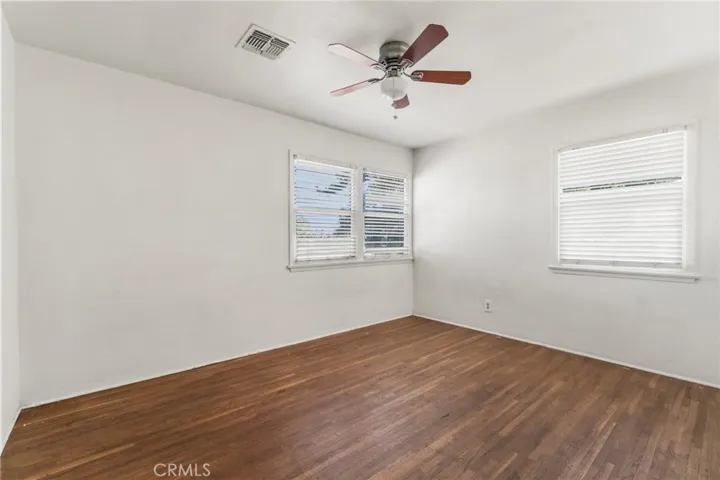 Bedroom with wood floors and ceiling fan