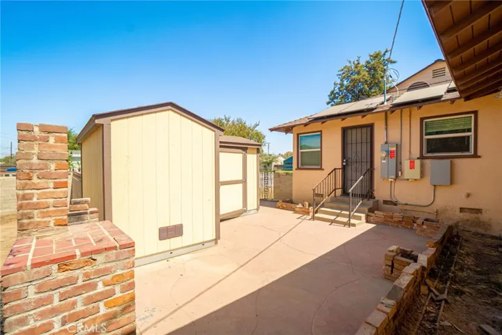 Big concrete patio with built in brick BBQ
